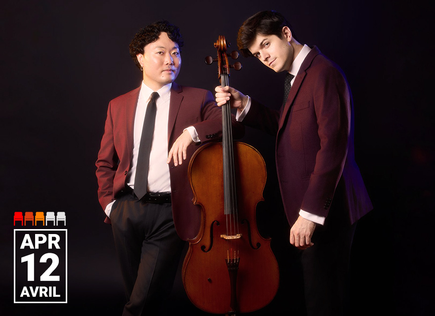 The image shows two men, both dressed in matching burgundy blazers, white shirts, and black ties, standing against a dark background. One man leans on a cello placed between them, while the other stands upright with his hand resting on the cello's neck. The cello is positioned vertically in the center of the image. At the bottom left corner, there is a graphic displaying the date "APR 12" with the word "AVRIL" underneath. The graphic also features a series of small icons resembling concert hall seating arrangements in red, orange, and gray.