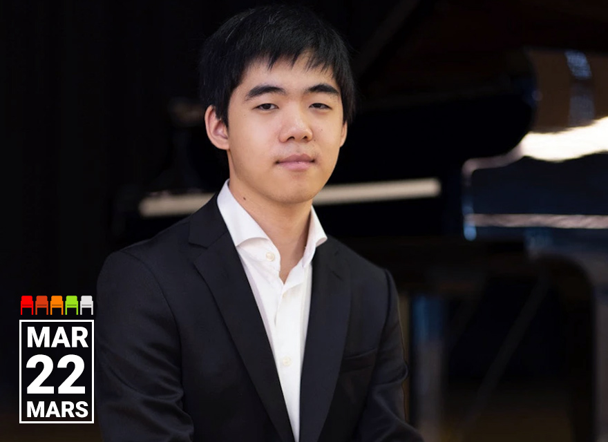 The image is a promotional photograph of a young pianist named Kevin Cheng dressed in a formal suit, sitting in front of a piano. The text "MAR 22 MARS" is displayed in the lower left corner, indicating the date of the event. The background is slightly out of focus, highlighting the subject, who appears composed and ready for a performance.