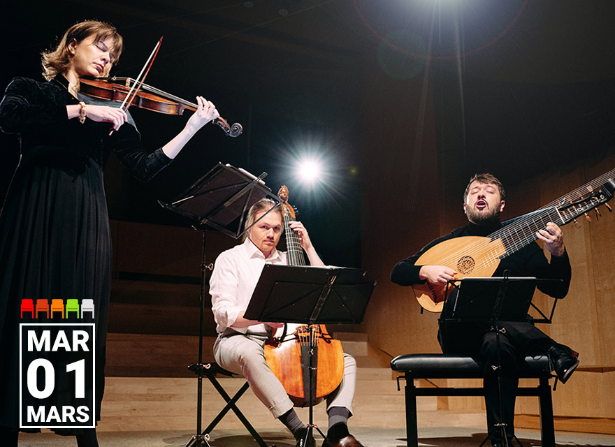 This image shows members of the Baroque Ensemble Francoeur performing on stage. The ensemble includes a violinist, a viol player, and a lutenist. The violinist stands while playing, the viol player and the lutenist are seated with their instruments. They are all focused on their performance, with music stands in front of them. The background is dimly lit, with a spotlight highlighting the performers. The date "Mar 01" is prominently displayed in the lower left corner.